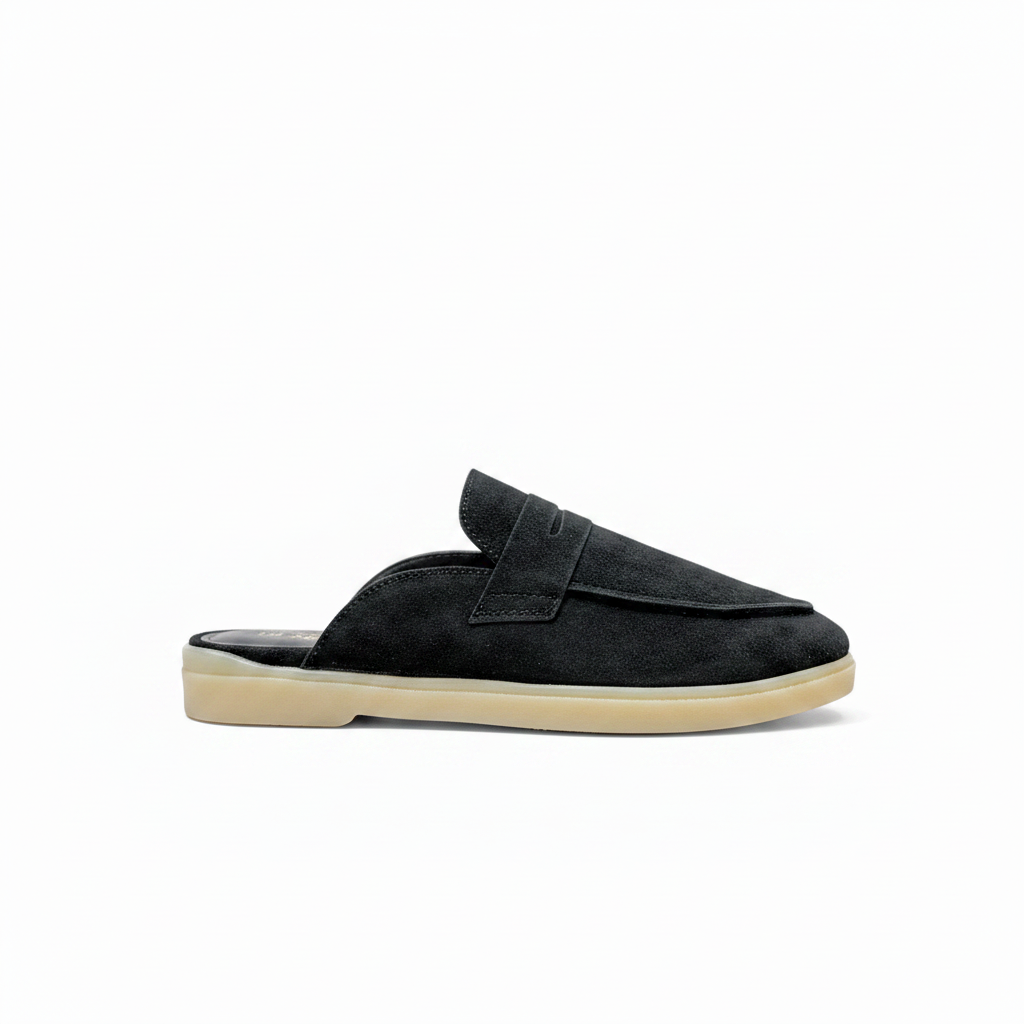 A single black suede mule slipper with a beige sole, shown in a side profile view against a plain white background.