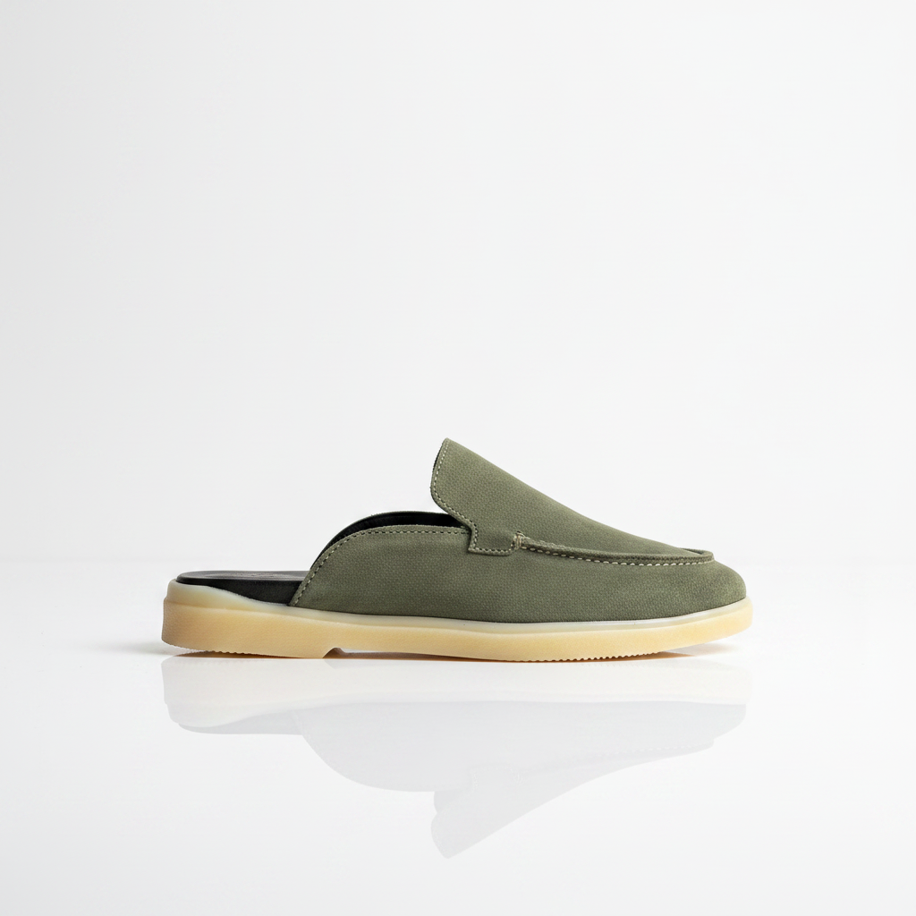 An olive green suede slip-on mule shoe with a light beige sole, shown in profile against a clean white background with a soft reflection below.